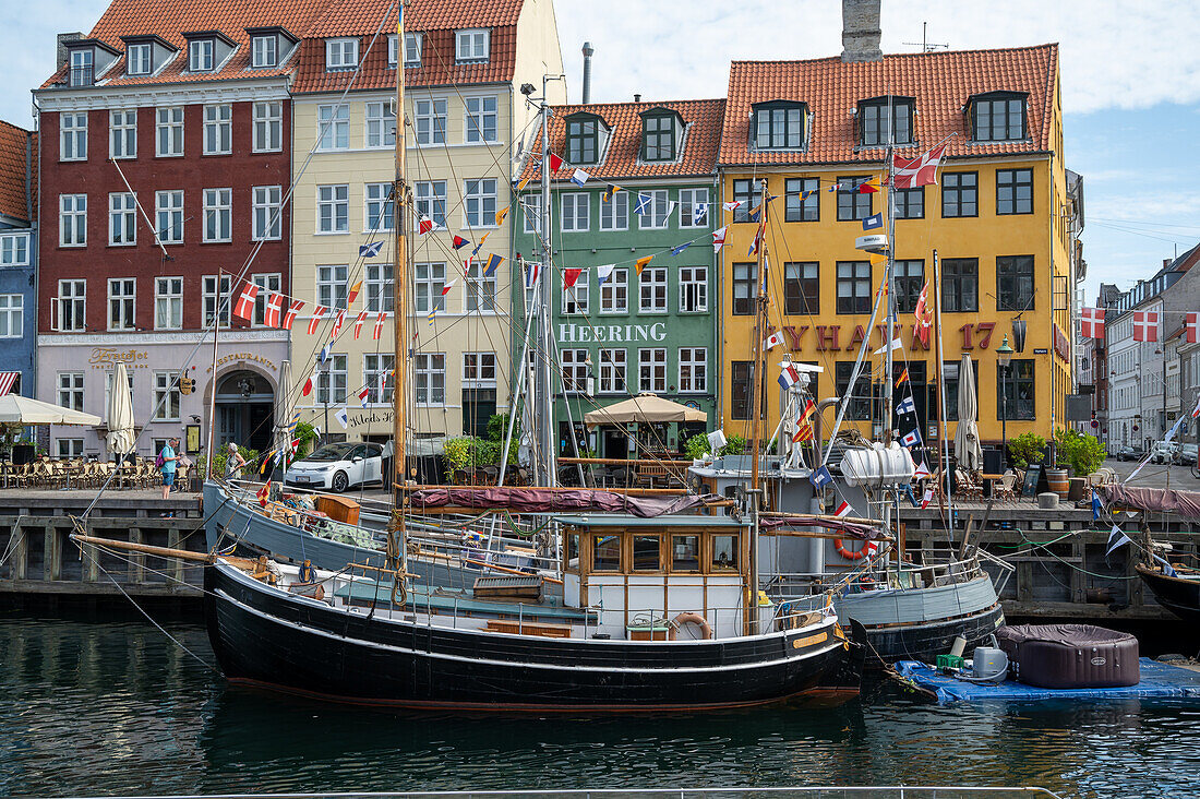 Colorfull facade and old ships along the Nyhavn Canal in Copenhagen Denmark