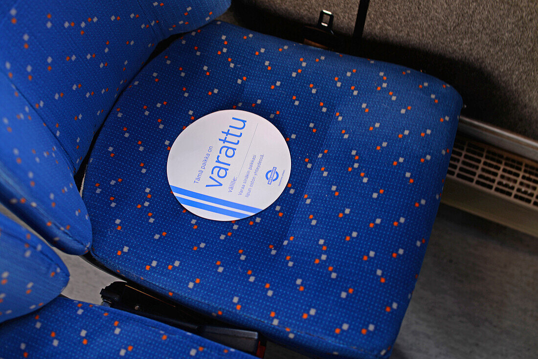 Sign in bus seat reads Varattu (Reserved in Finnish)