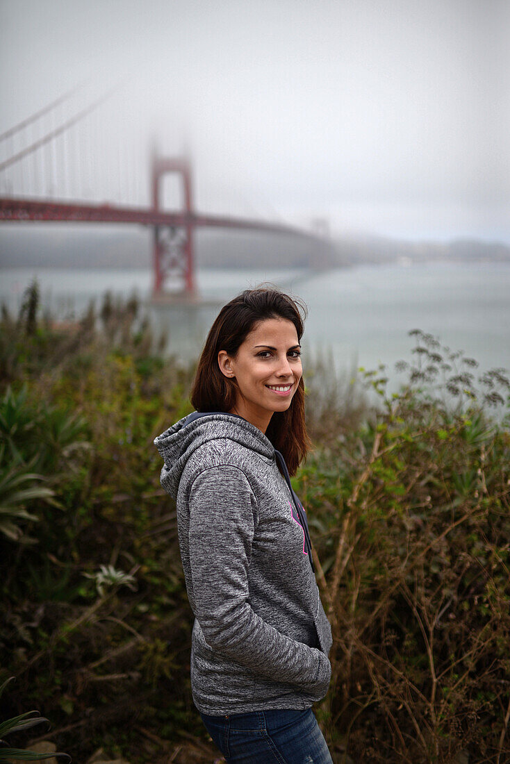 Young woman and Golden Gate Bridge, San Francisco.
