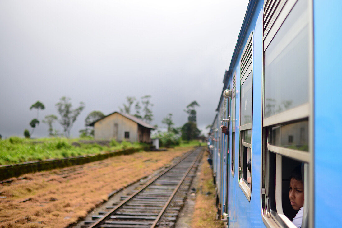 Portrait of young boy in window. Train ride from Kandy to Nuwara Eliya, Sri Lanka