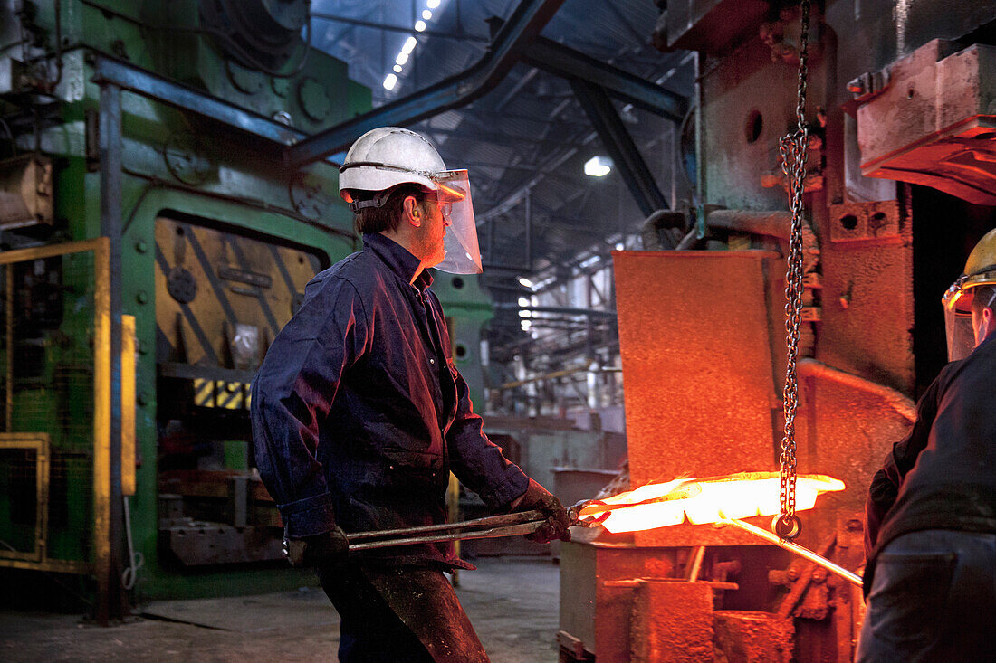 Flight bar (mining component) having been forged in 15 mt counterblow hammer, is moved to clipping press to clip off excess "flash"