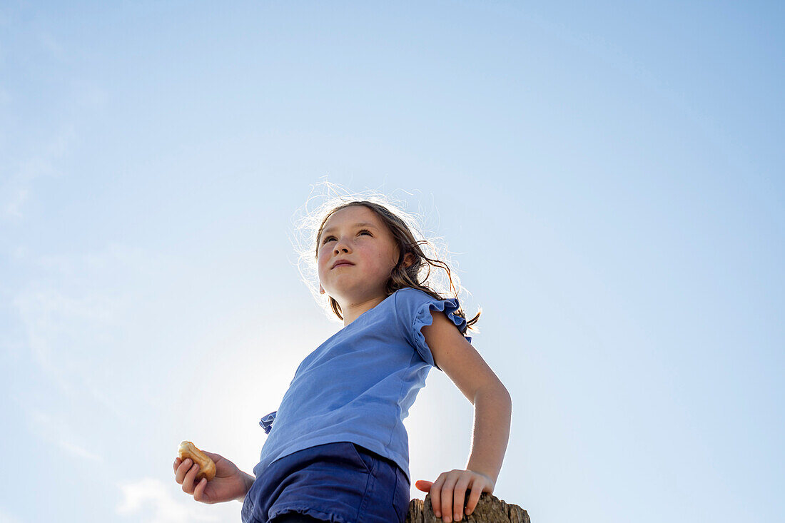 Low angle view of girl (4-5)Êagainst clear sky