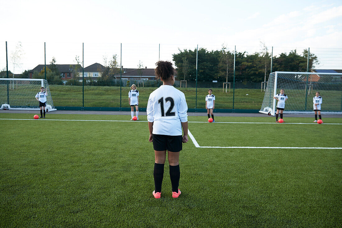 UK, Girls soccer team (10-11, 12-13) having training in field