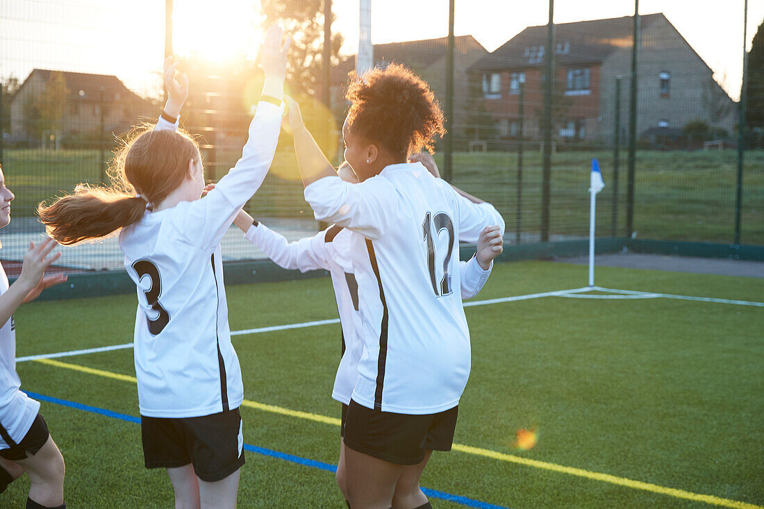 UK, Fußballspielerinnen (10-11, 12-13) jubelnd auf einem Feld