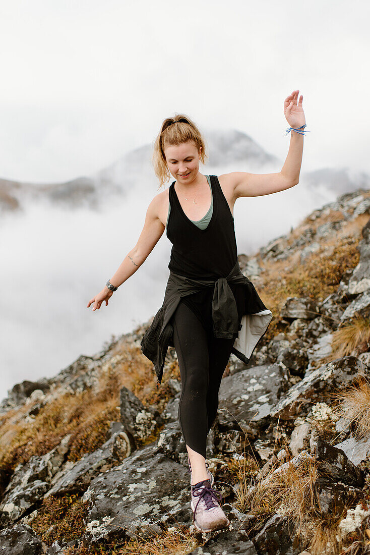 Canada, Yukon, Whitehorse, Woman walking on rocky hillside