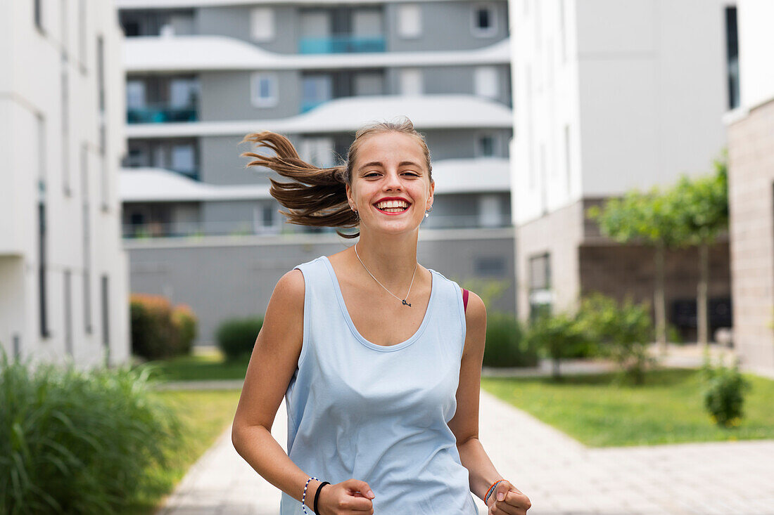 Smiling young woman jogging