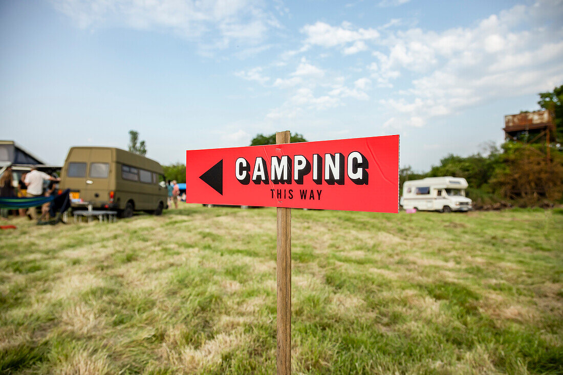 UK, Sussex, Camping sign with camper trailers in background