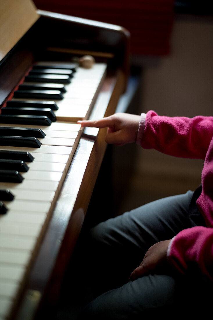 Hand of girl (4-5) playing piano