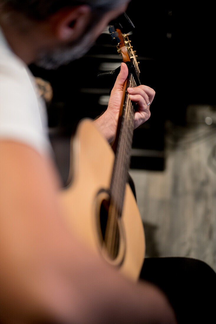 Close-up of man playing guitar