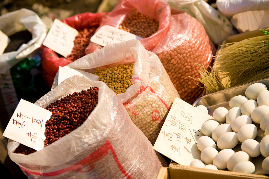 China, Shanghai, Close-up of bags of beans and eggs on farmers market