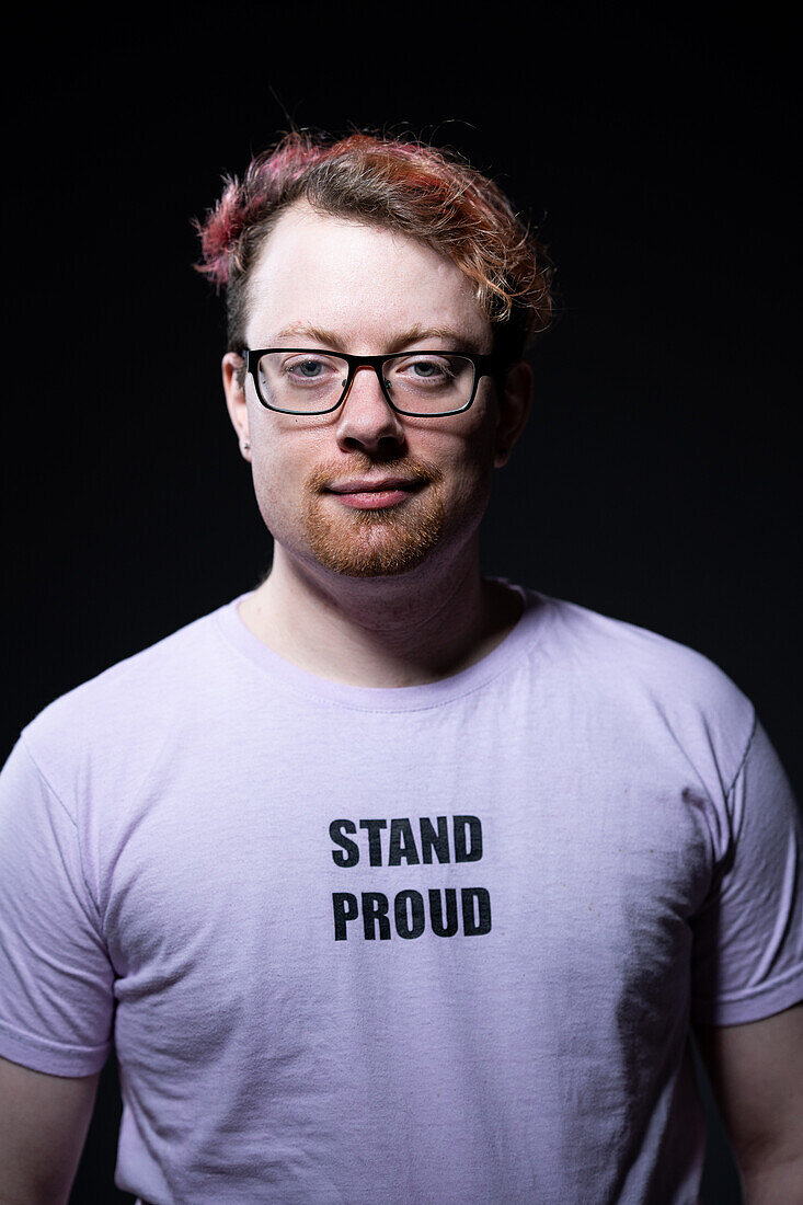 Studio portrait of man wearing eyeglasses and white t-shirt