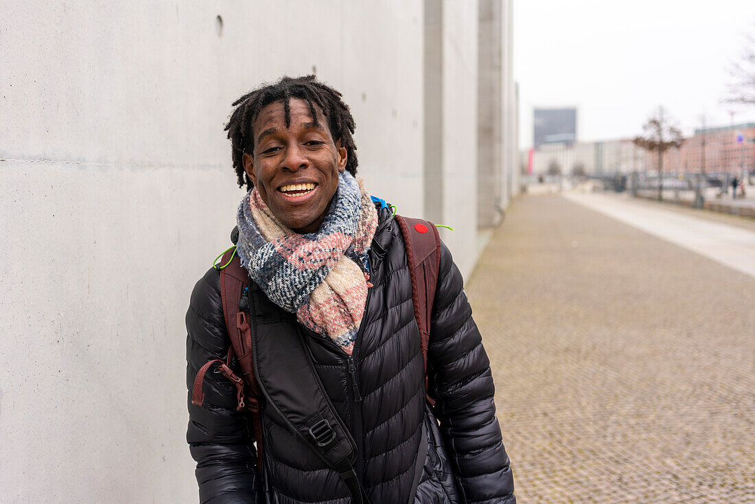 Germany, Berlin, Portrait of smiling man in city