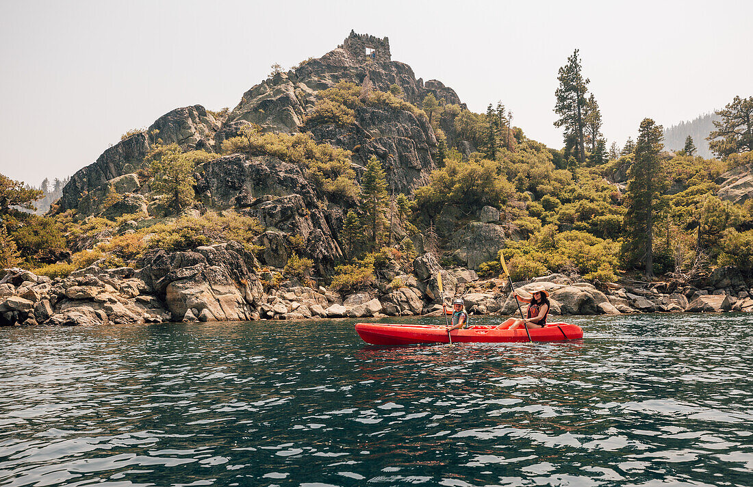 Woman with daughter (7-8) in kayak at lake