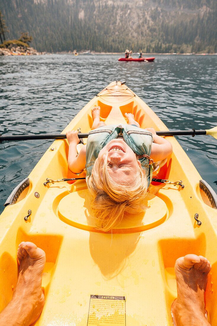 Smiling boy (8-9) in kayak