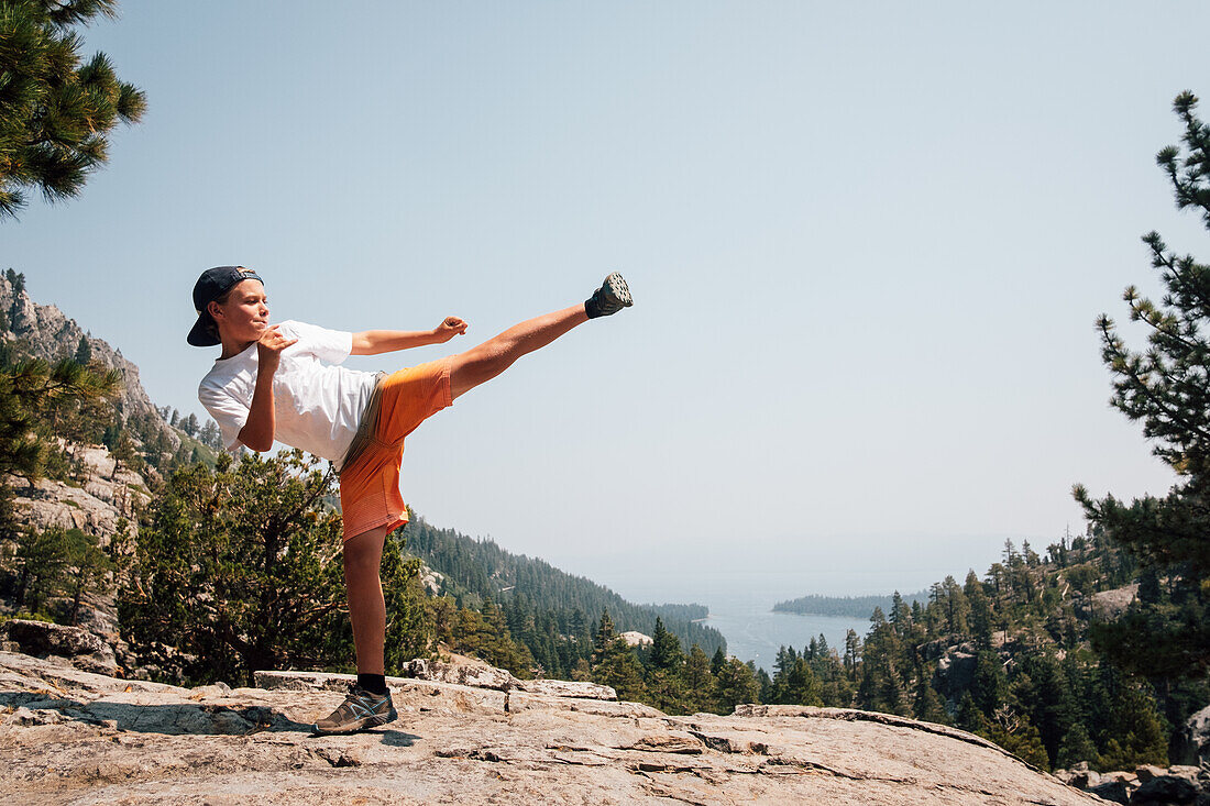 Boy (12-13) doing karate kick