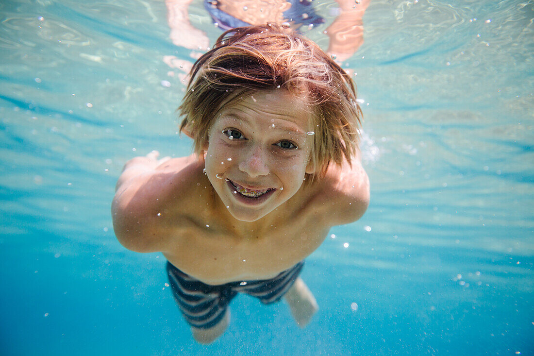 Portrait of boy (12-13) underwater