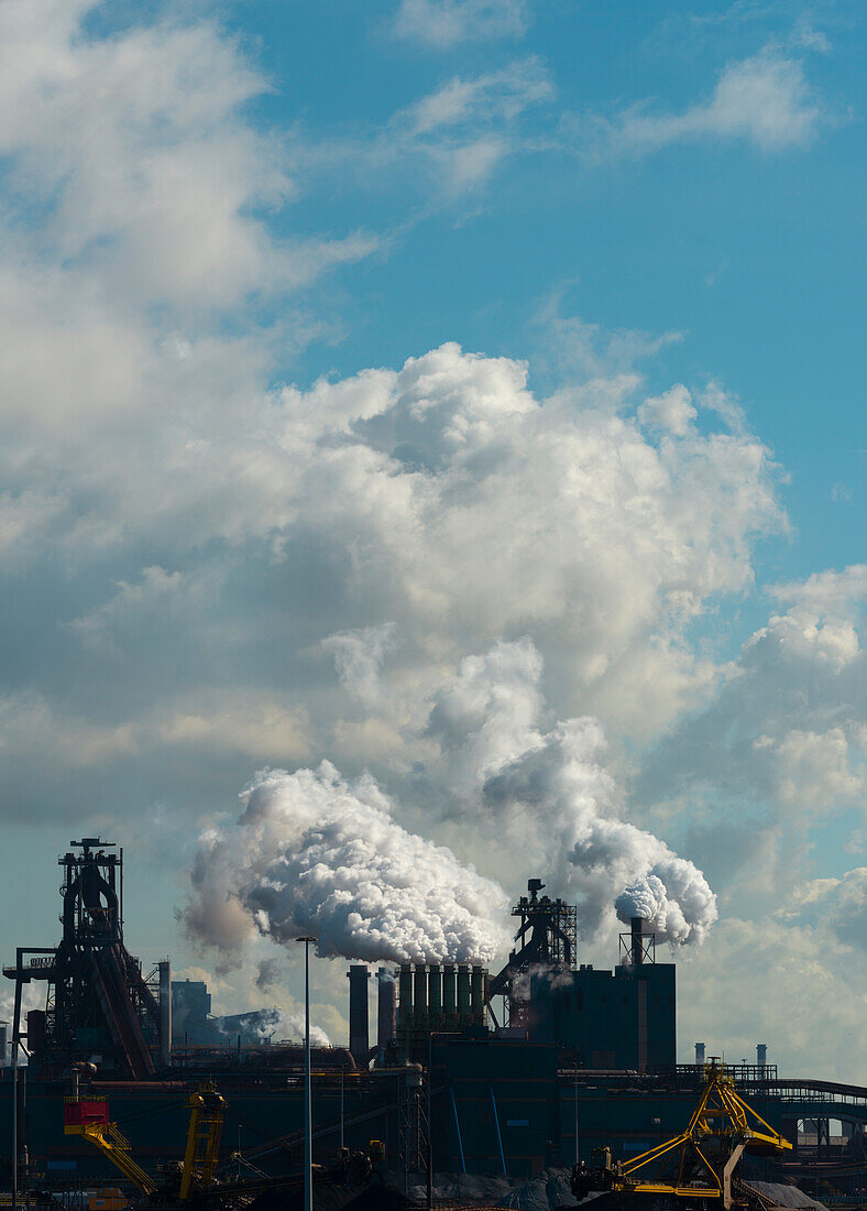 Clouds above steel mill emitting steam