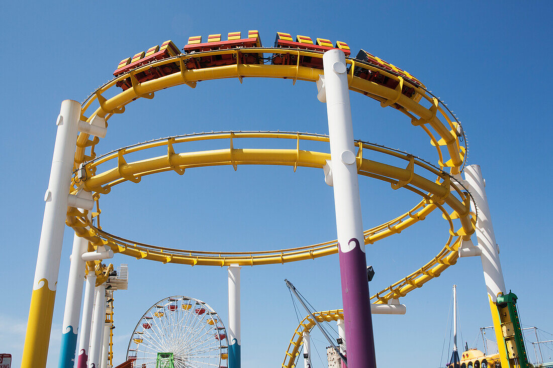 Amusement Park Roller Coaster Against A Blue Sky; California, United States Of America