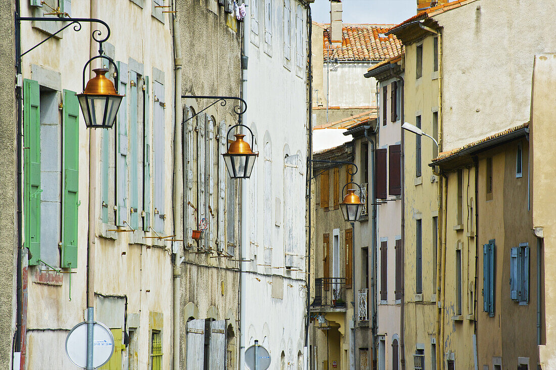 Weathered Residential Buildings With Colourful Shutters On The Windows; Cite, France