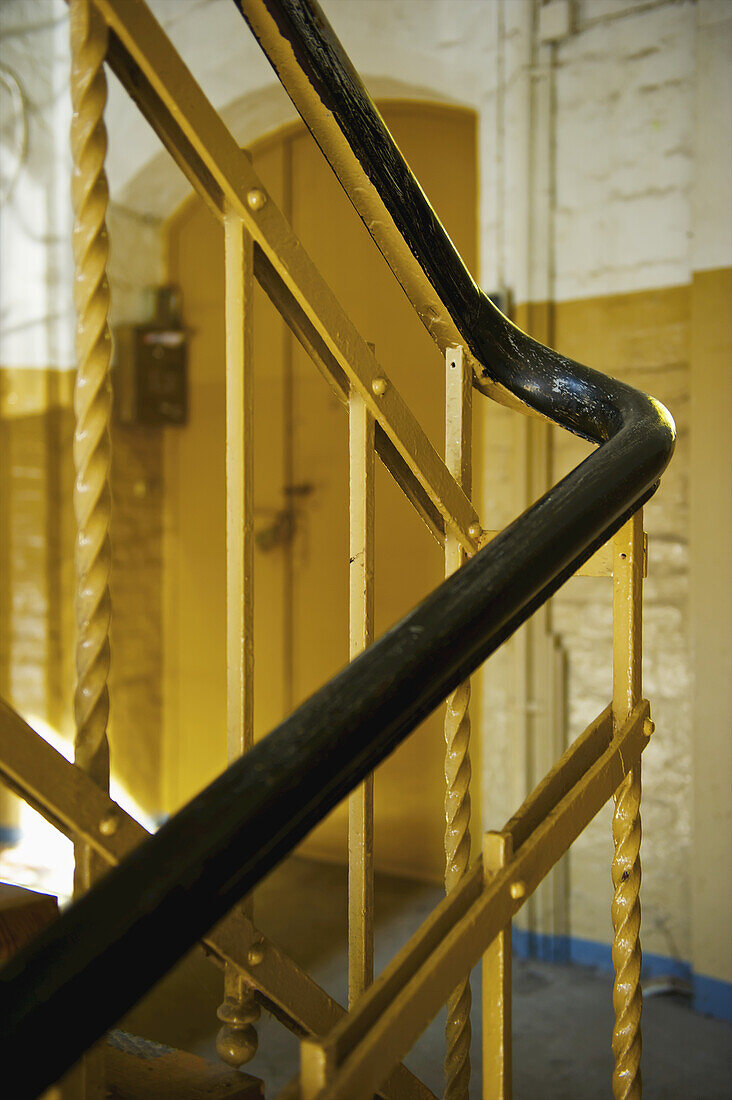 A Black Handrail And Yellow Painted Metal Balusters Inside A Building; Hamburg, Germany