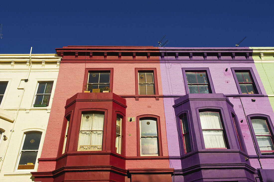 Bunte Fassaden von Wohngebäuden in einer Reihe, Notting Hill; London, England