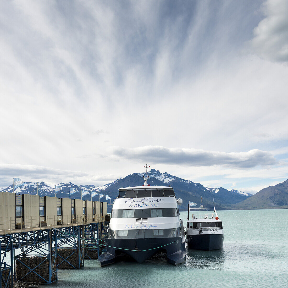 Boats Moored On The Side Of A Dock In A Lake; Santa Cruz Province, Argentina