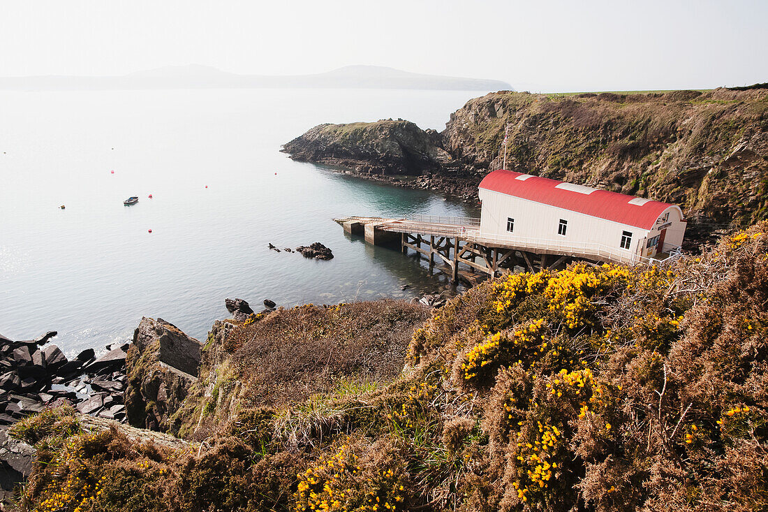 St. Justinian's Lifeboat Station With Ramsey Island In Distance On Pembrokeshire Coast Path; Pembrokeshire, Wales