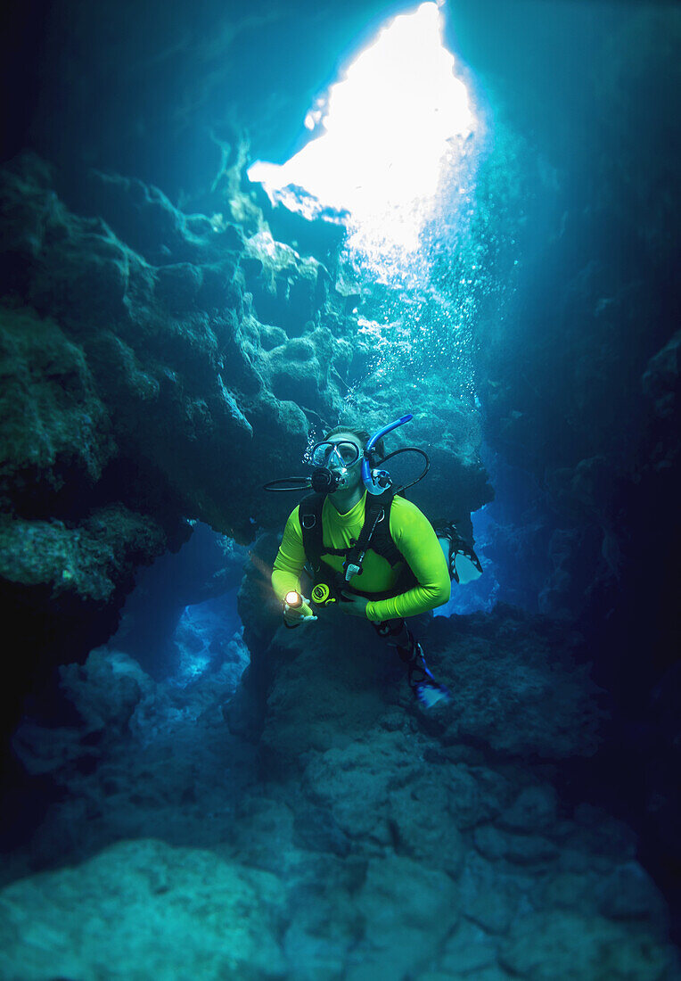 Diving Into One Of The Underwater Caves That Surround Niue; Niue Island