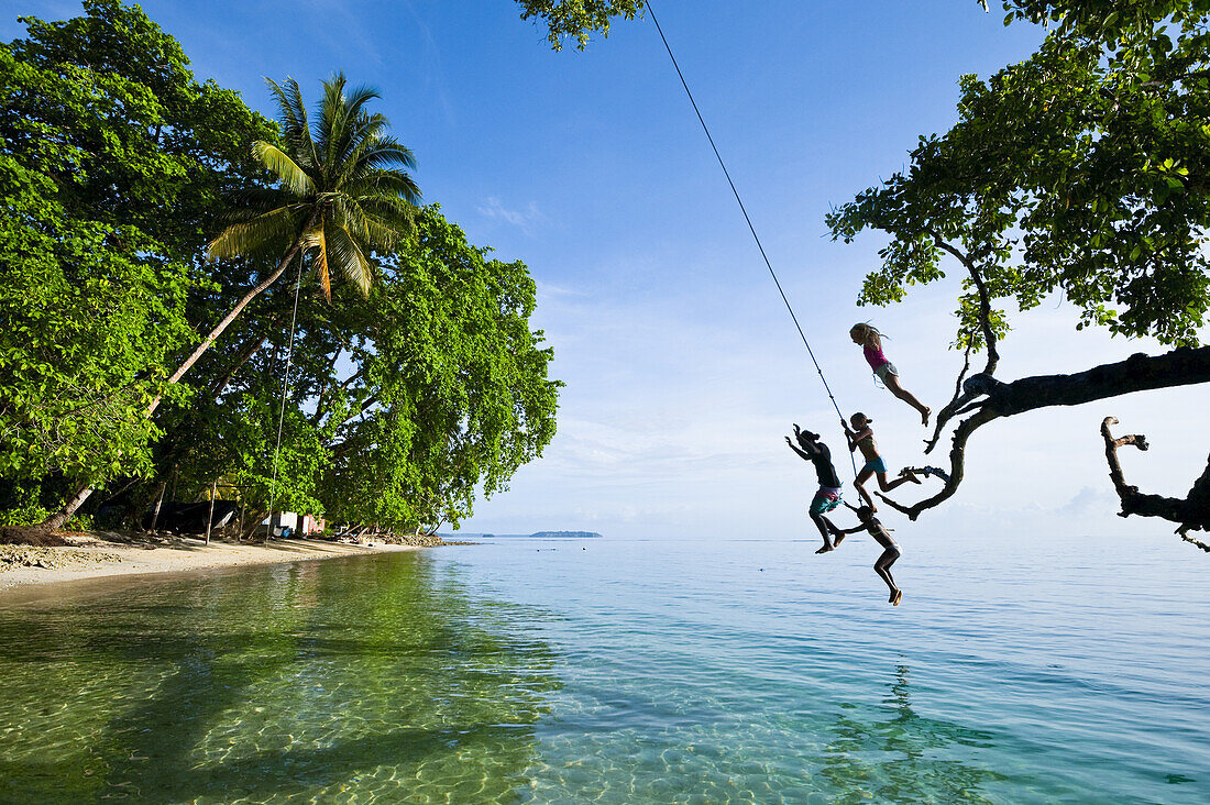 Solomon Island Kids Swinging From A Rope; Gizo, Western Province, Solomon Islands