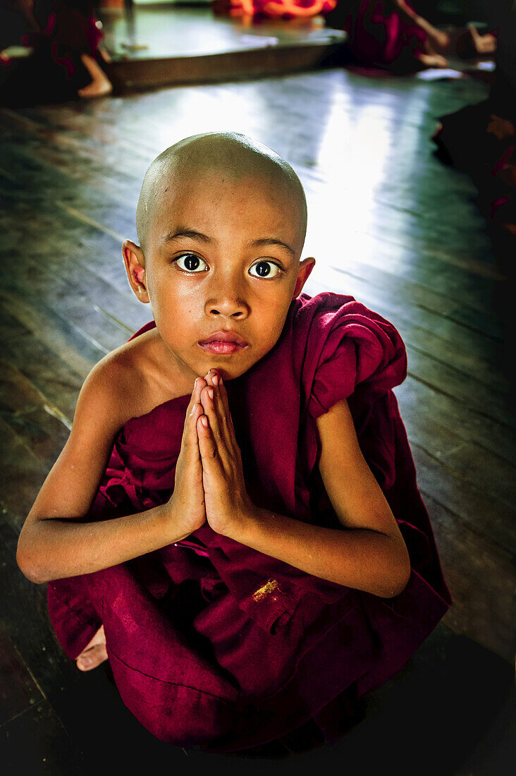 Young Monk Praying At Myanmar Monastery; Yangoon, Myanmar