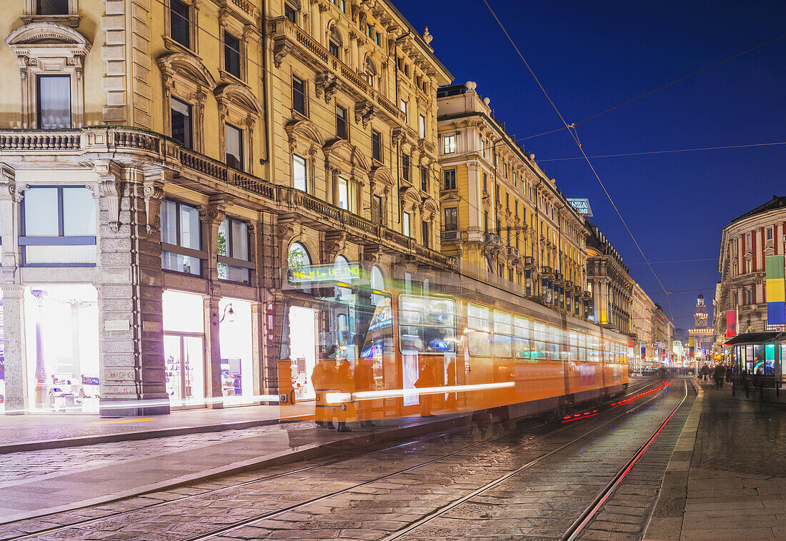 Motion Blur Of The Tram Traveling Down The Street; Milan, Lombardy, Italy