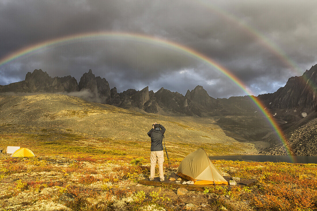 Photographer Taking Pictures Of The Late Afternoon Light Hitting The Mountains In The Tombstone Territorial Park Of The Northern Yukon; Yukon, Canada