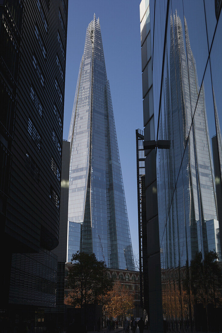 The Shard Skyscraper By Renzo Piano Near London Bridge On The South Bank, Seen Between And Reflected In Other Nearby New Office Buildings; London, England