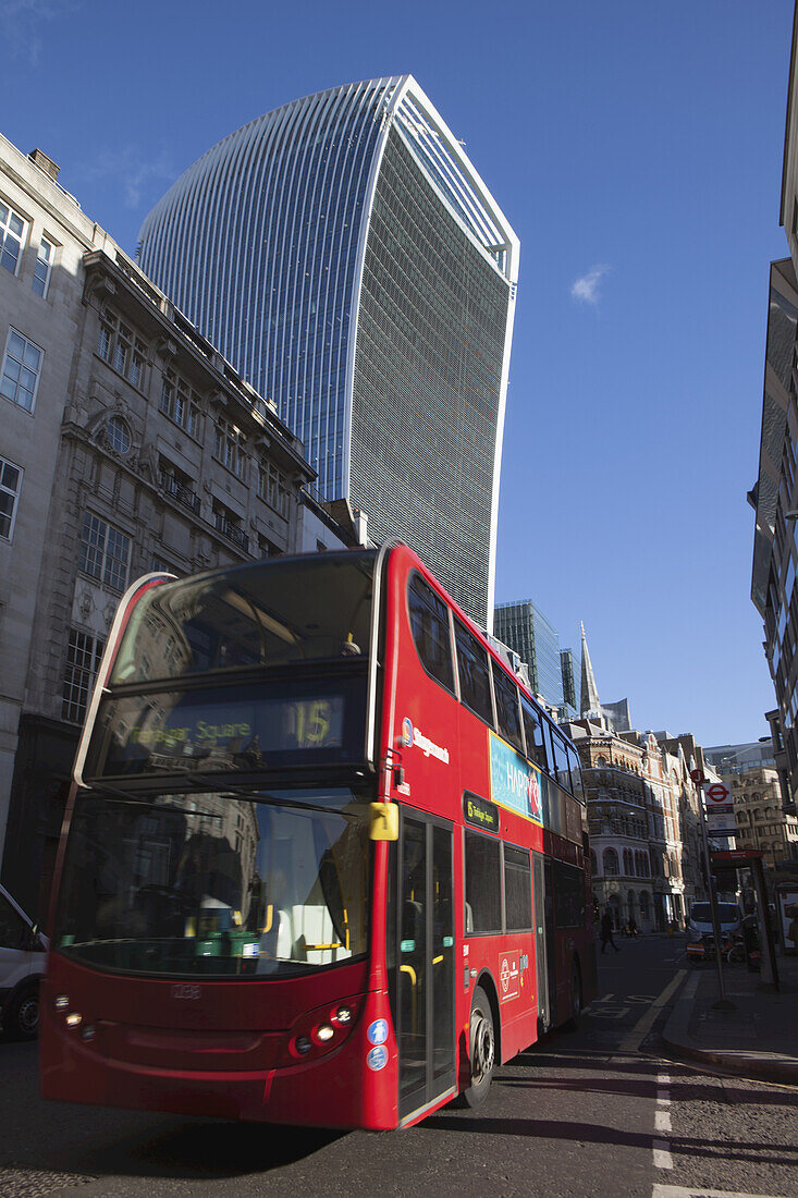 A Red London Double-Decker Bus Passes In Front Of The Walkie Talkie Building, 20 Fenchurch Street, Designed By Rafael Vinoly; London, England