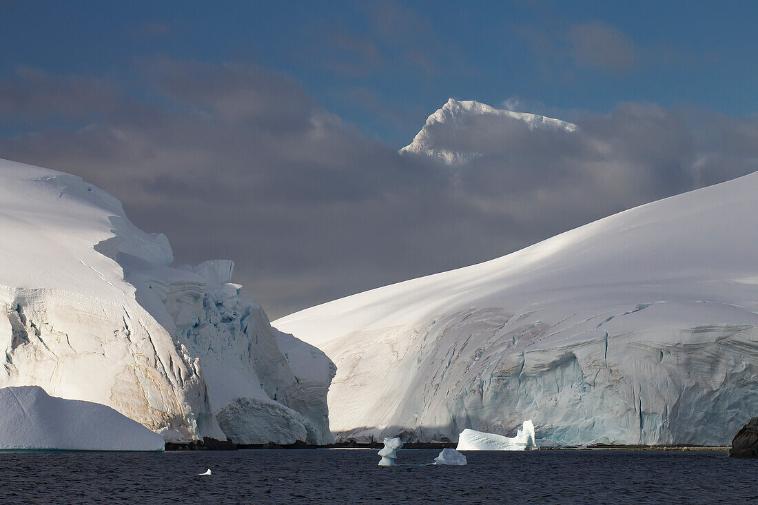Glacier Covered Melchior Islands, Peaks Of Brabant Island In Background, Antarctic Peninsula; Antarctica