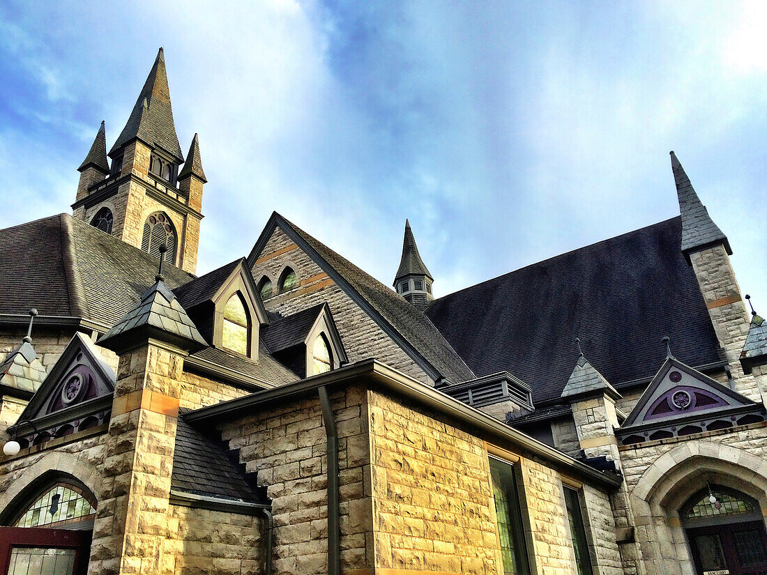 The many spires and gables of the United Church of Granville, an early 19th century stone church, rising up toward the sky; Granville, Ohio, United States of America