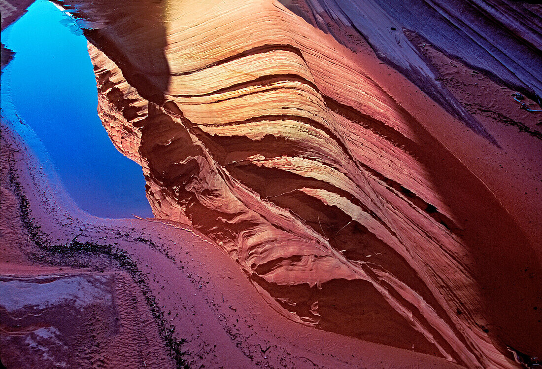 Spectacular formation of vibrant colors in swirls of fragile sandstone is known as The Wave and is located in the Coyote Buttes section of Vermilion Cliffs National Monument. An unmarked wilderness trail limits hikers and requires a permit from the Bureau of Land Management; Arizona, United States of America