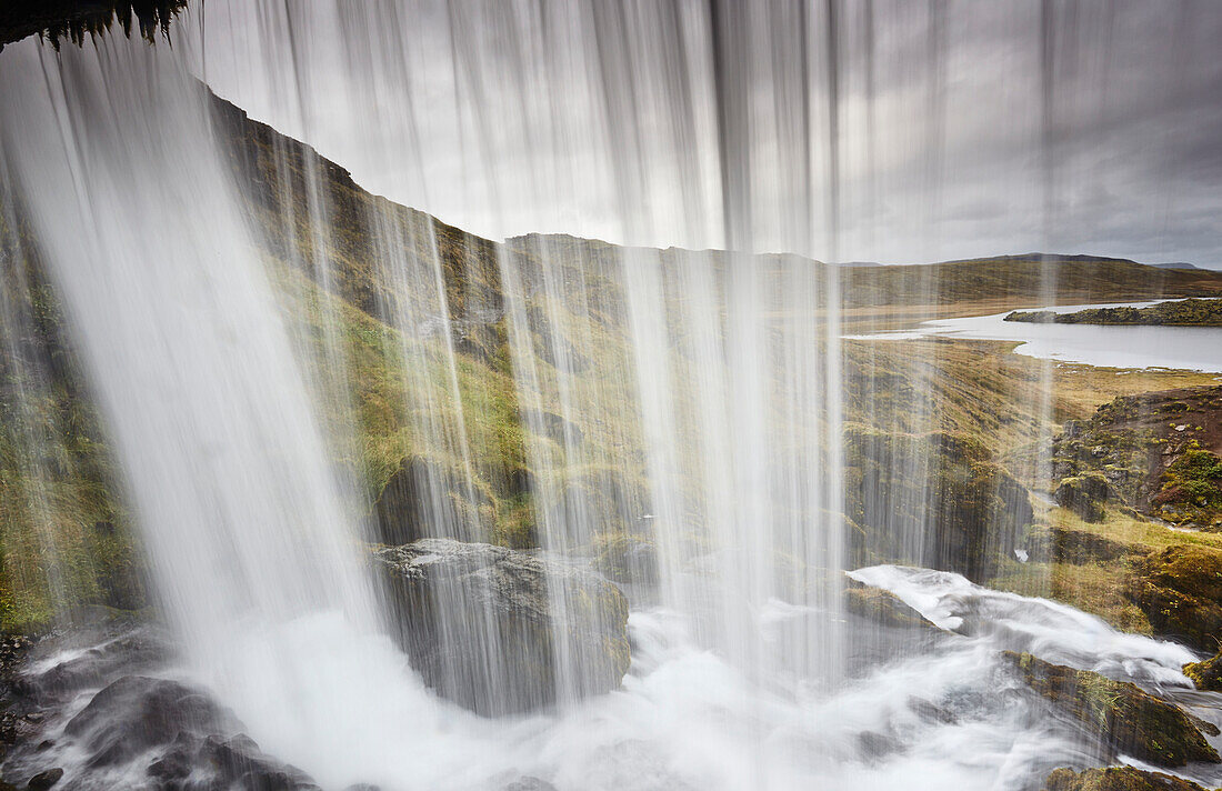 Moss covered rock and the rugged beauty of Hafrafell waterfall in mountains near Stykkisholmur, Snaefellsnes peninsula in Western Iceland; Iceland