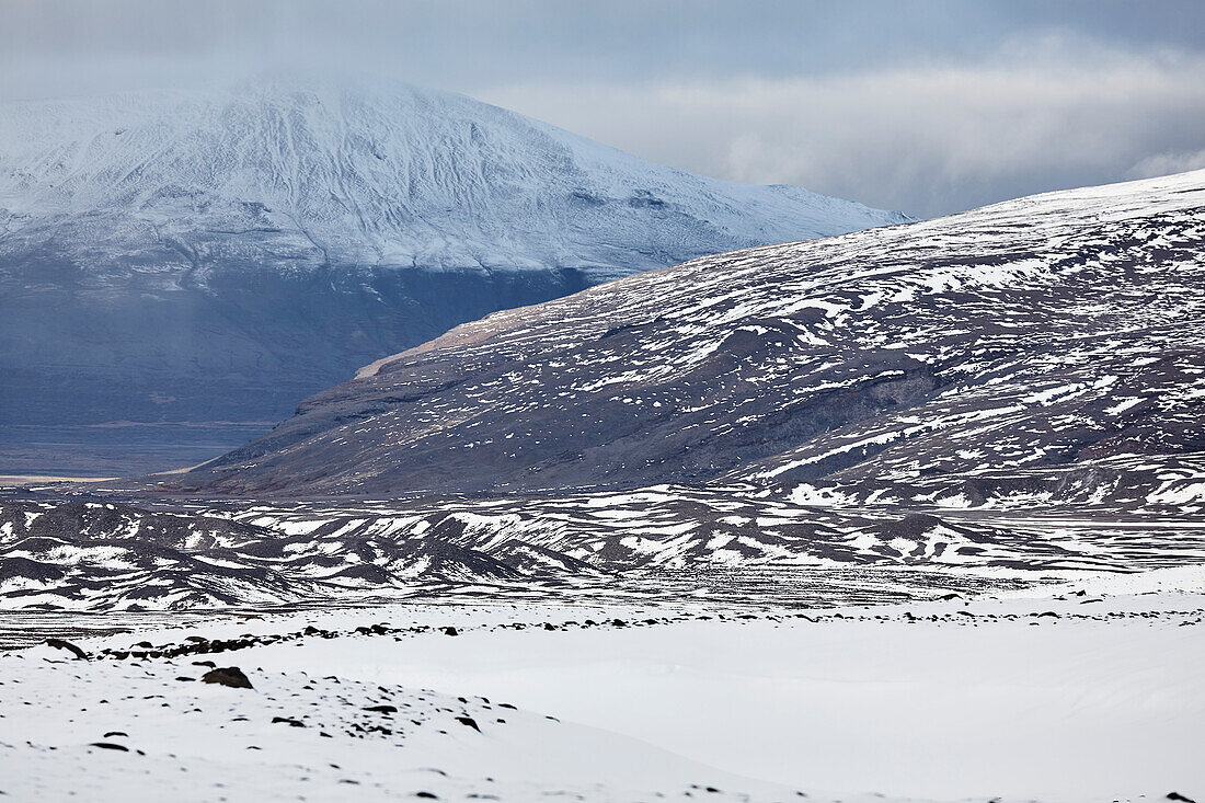 Snow-clad mountains in early winter in the Kaldidalur Valley, seen from Langjokull Glacier, in the western Highlands of west Iceland; Iceland