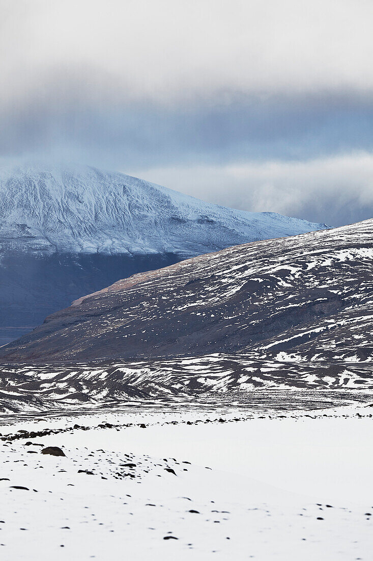 Snow-clad mountains in early winter in the Kaldidalur Valley, seen from Langjokull Glacier, in the western Highlands of west Iceland; Iceland