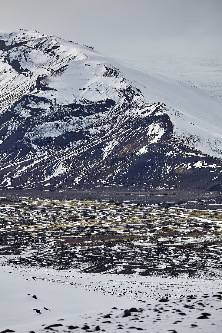 Snow-clad mountains in early winter in the Kaldidalur Valley, seen from Langjokull Glacier, in the western Highlands of west Iceland; Iceland