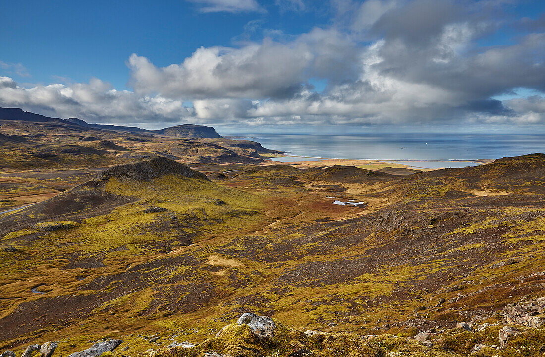 Harsh and rugged landscape along the coast of Iceland, with a view of the north coast from Valafell mountain pass, looking towards Olafsvik, Snaefellsnes peninsula, west coast of Iceland; Iceland