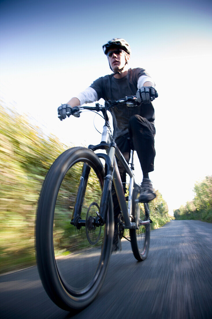 Man cycling on a country road