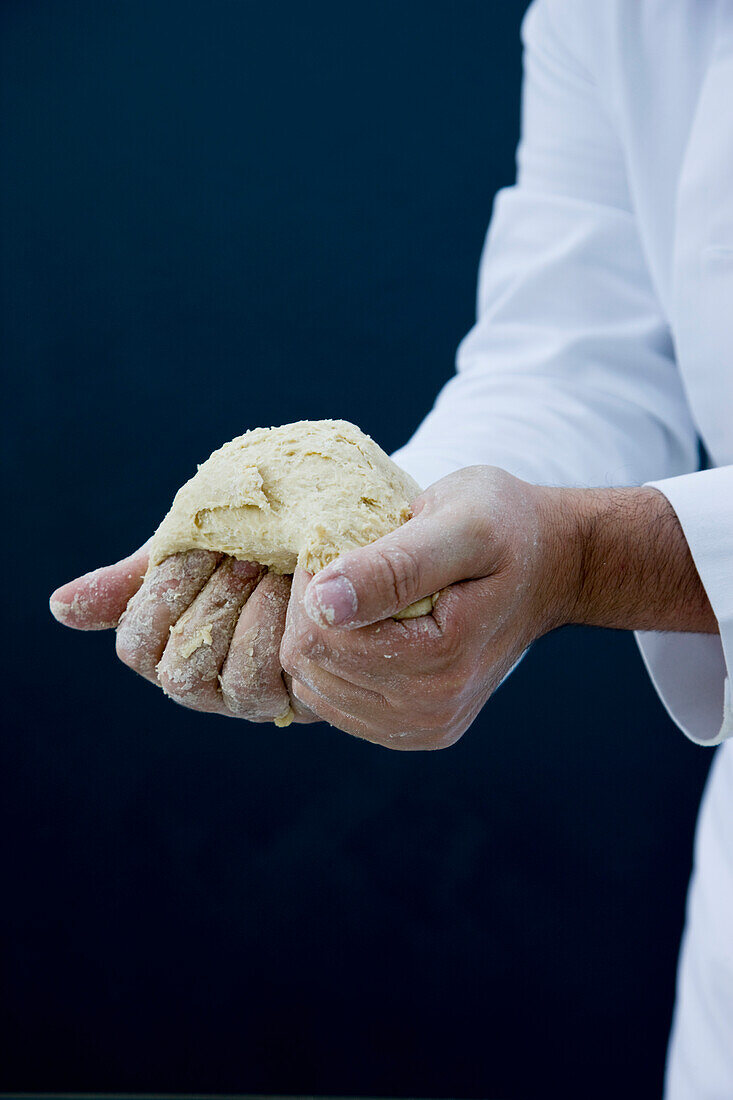 Close up of a chef hands kneading pizza dough