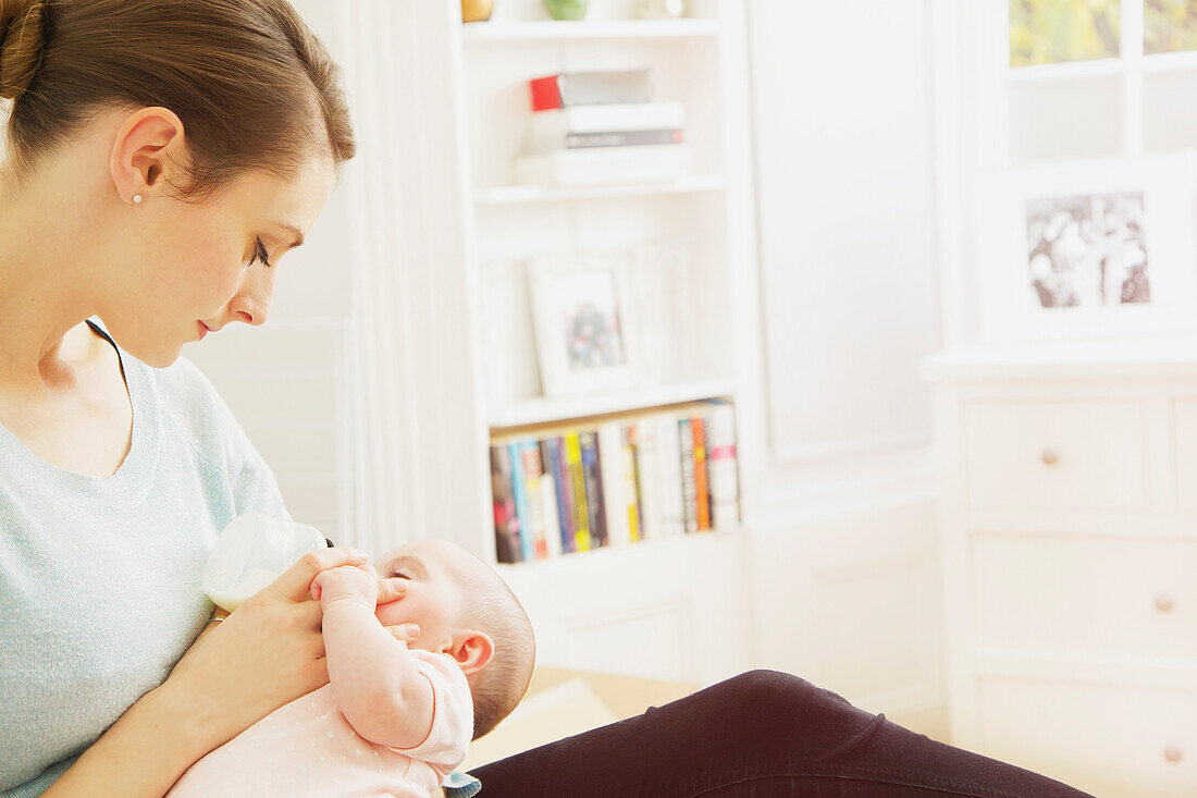 Mother Bottle Feeding Baby Girl