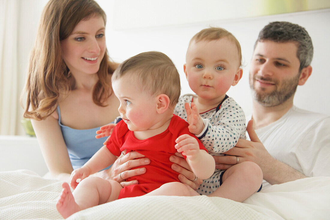 Couple in Bed with Baby Twins