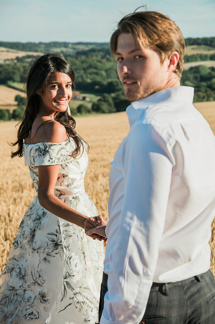 Couple in a Field Holding Hands