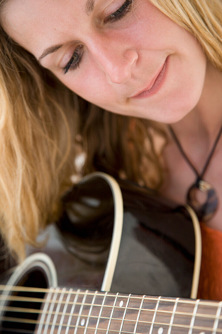 Close up of Woman Playing Guitar