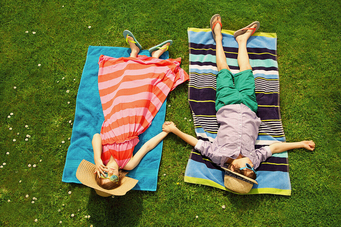 Boy and Girl Sunbathing on Lawn