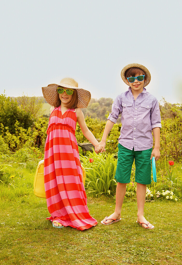 Boy and Girl Wearing Straw Hat and Sunglasses Smiling
